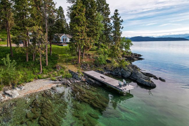 Dock area featuring a water and mountain view | Image 14