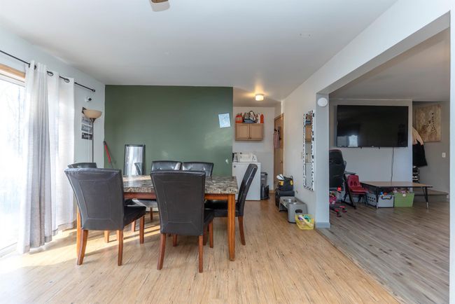 Dining room featuring light wood-style floors and washer / dryer | Image 27