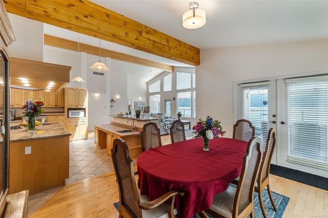 Dining space with light wood-style flooring and french doors | Image 15