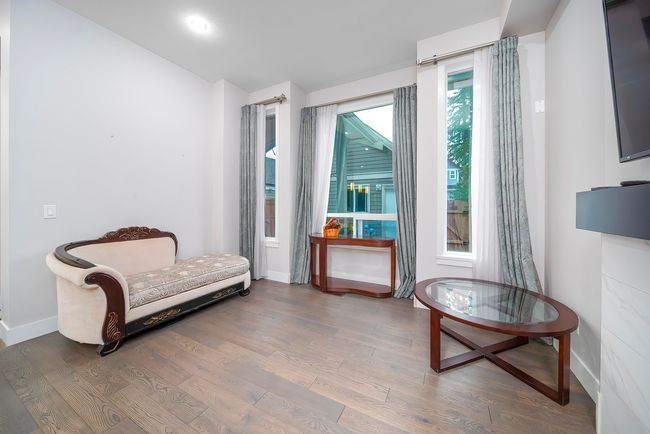 Sitting room with wood finished floors and baseboards | Image 9