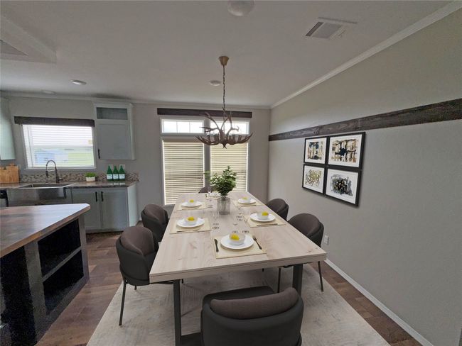 Dining area with dark wood-style floors, a chandelier, and ornamental molding | Image 4