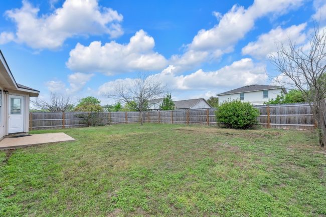 View of yard featuring a fenced backyard and a patio | Image 17