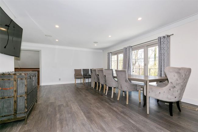 Dining space featuring visible vents, ornamental molding, dark wood finished floors, and baseboards | Image 4