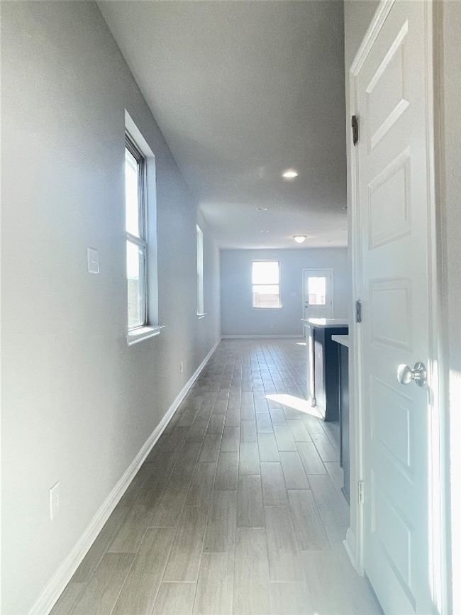 Hall with wood finished floors and recessed lighting | Image 7