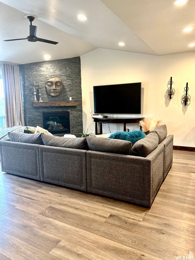 Living room with lofted ceiling & a stone fireplace. | Image 9