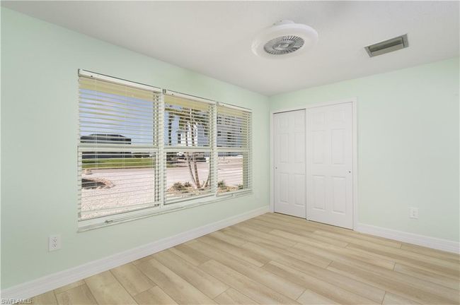 Bedroom with a closet, vinyl wood finished floors, and fan. | Image 12