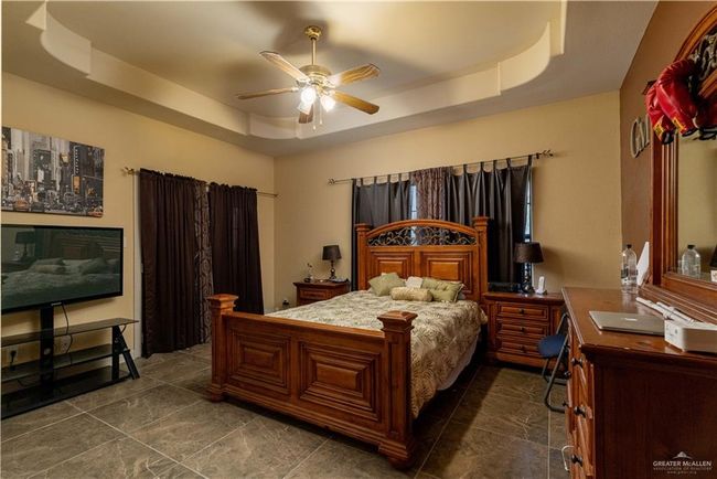 Bedroom with a tray ceiling and ceiling fan | Image 20