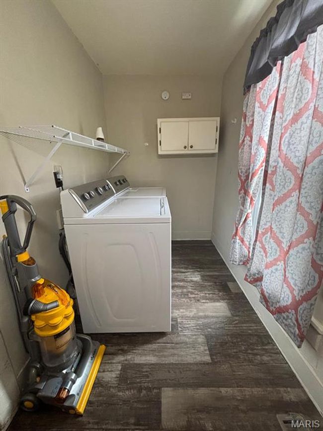 Laundry room featuring independent washer and dryer and dark wood-style floors | Image 23
