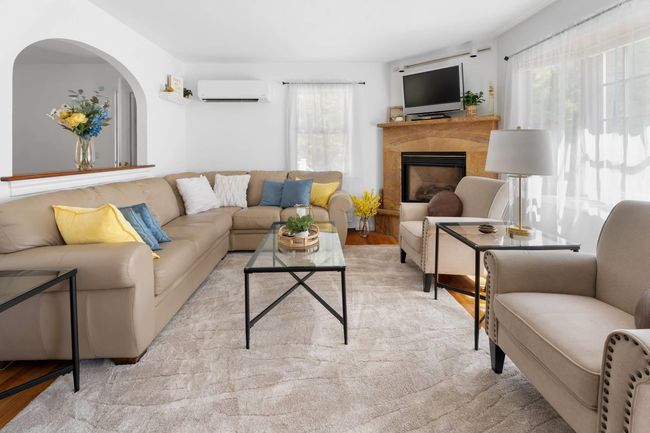 Living room featuring light hardwood / wood-style floors and an AC wall unit | Image 9