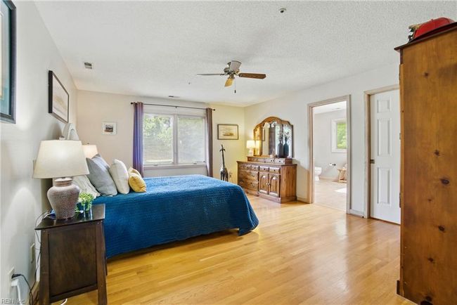 Primary bedroom with oak floors, large ensuite, and walk-in closet. | Image 25