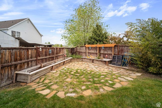 View of yard featuring a vegetable garden and a fenced backyard | Image 33