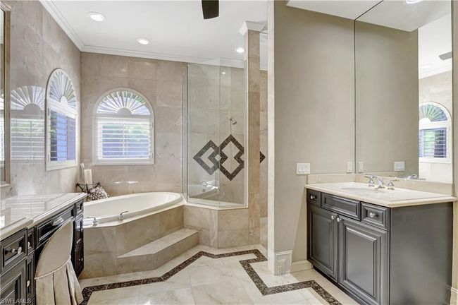 Bathroom with a bath, tiled shower, vanity, and plenty of natural light | Image 29