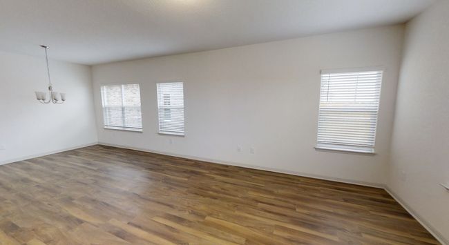 Unfurnished room with wood finished floors and a chandelier | Image 5