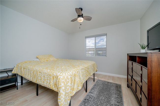 Bedroom featuring baseboards, a ceiling fan, and light wood-style flooring | Image 21