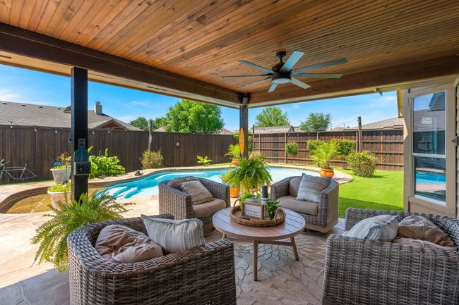 Fenced backyard with a ceiling fan, a patio, and an outdoor living space | Image 32