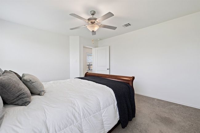 Carpeted bedroom featuring a ceiling fan | Image 19