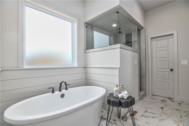 Bathroom with a healthy amount of sunlight, tile patterned floors, and independent shower and bath | Image 26