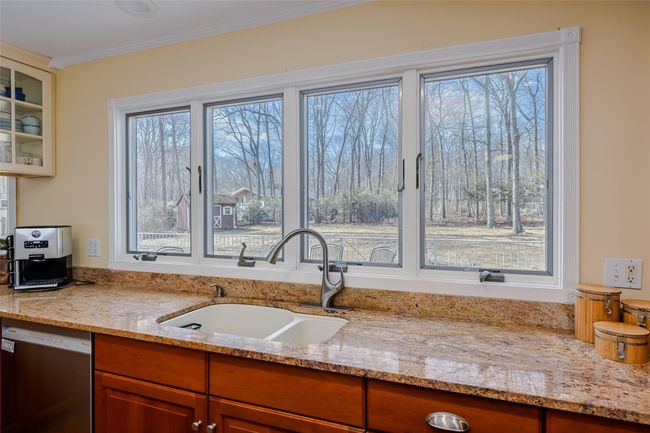 Kitchen with a sink, glass insert cabinets, plenty of natural light, and dishwasher | Image 14