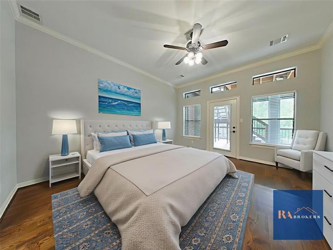 Spacious downstairs primary bedroom with direct porch access. (virtually staged) | Image 17