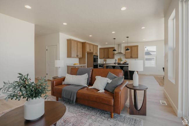 Living room featuring visible vents, light wood-style flooring, recessed lighting, and baseboards | Image 6