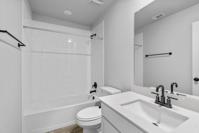 Full bath featuring vanity, visible vents, toilet, and shower / washtub combination | Image 20