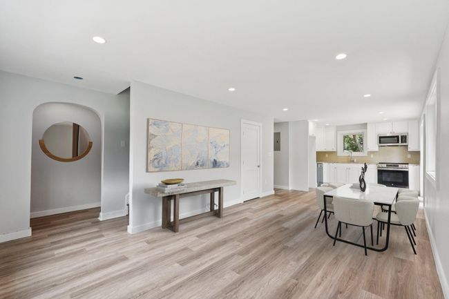 Kitchen/stainless steel appliances, white cabinets, light wood finished floors, recessed lighting, and light countertops Virtually Staged | Image 4