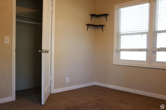 Unfurnished bedroom with carpet floors and baseboards | Image 11