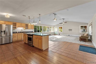 Enormous Great Room w/lots of windows, new carpet, ceramic tile, corian island & ceiling fans. | Image 3