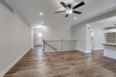 Empty room with hardwood / wood-style floors and ceiling fan | Image 3