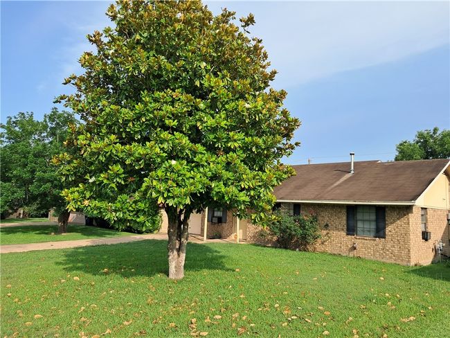 View of front of home featuring a front lawn and brick siding | Image 18