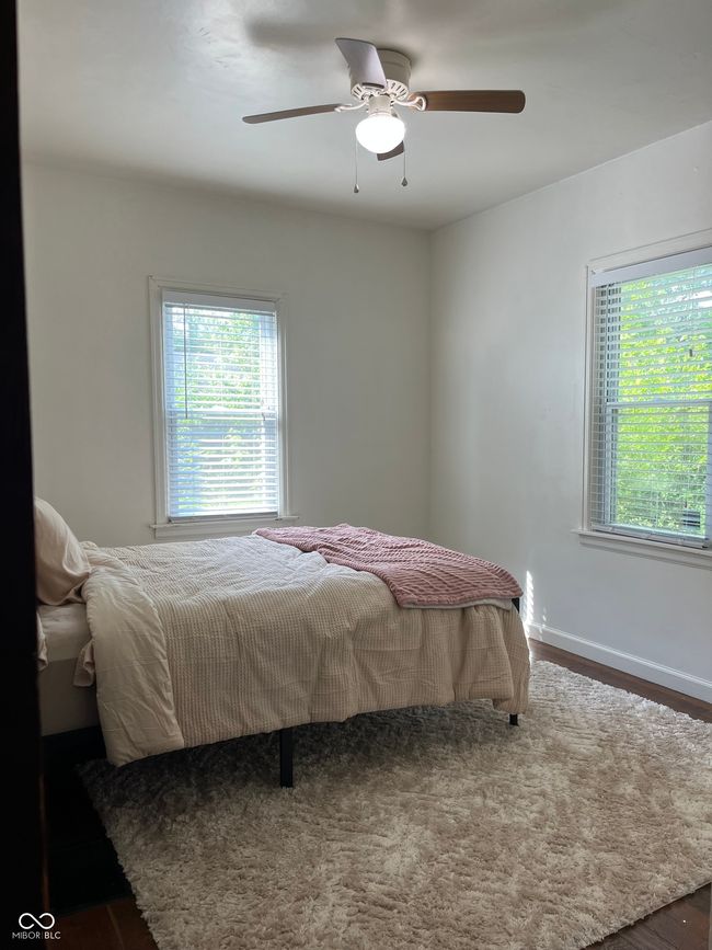 bedroom with a ceiling fan and wood finished floors | Image 13