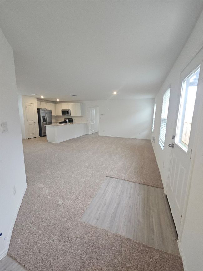 Unfurnished living room featuring recessed lighting, light carpet, and baseboards | Image 15