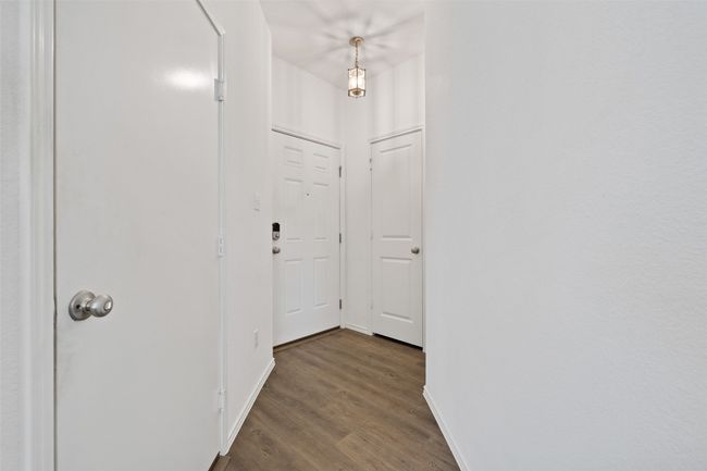 Hall with wood finished floors and baseboards | Image 5