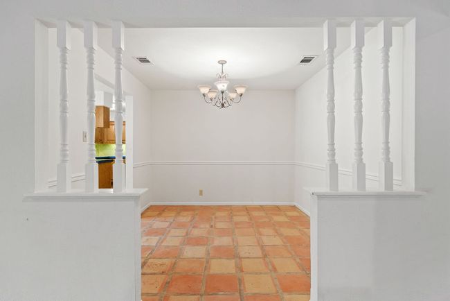 Unfurnished dining area with a chandelier and baseboards | Image 15