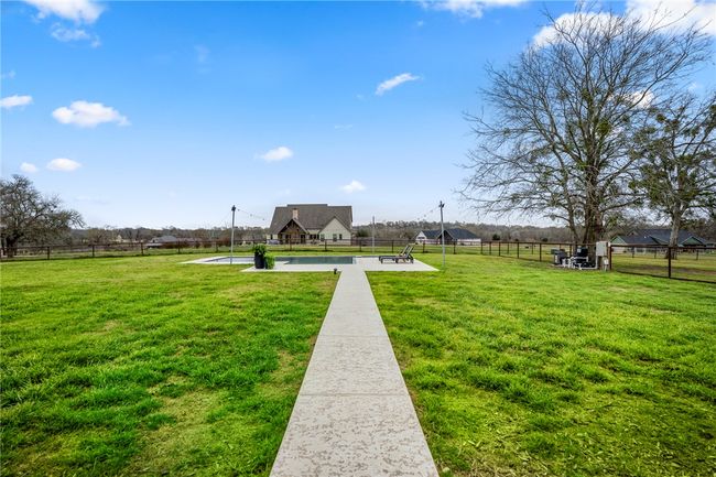 View of home's community featuring fence and a lawn | Image 44