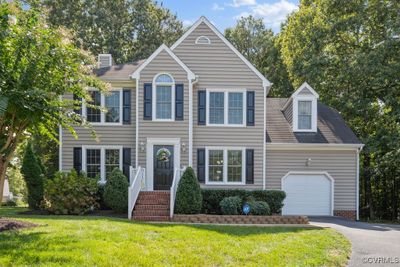 View of front of property with a garage and a front yard | Image 1