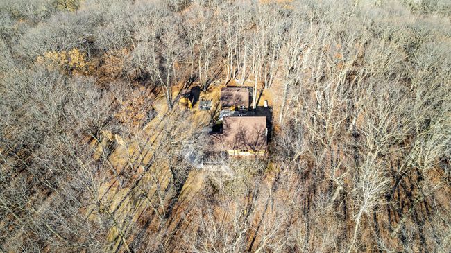 Drone footage of the heavily wooded lot. This home is nestled among mature oak trees, creating a private retreat. | Image 40