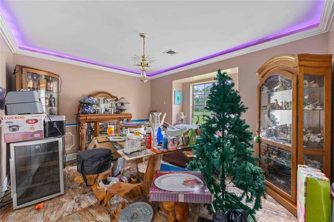 This is the formal dining room with crown molding and LED lighting. | Image 4