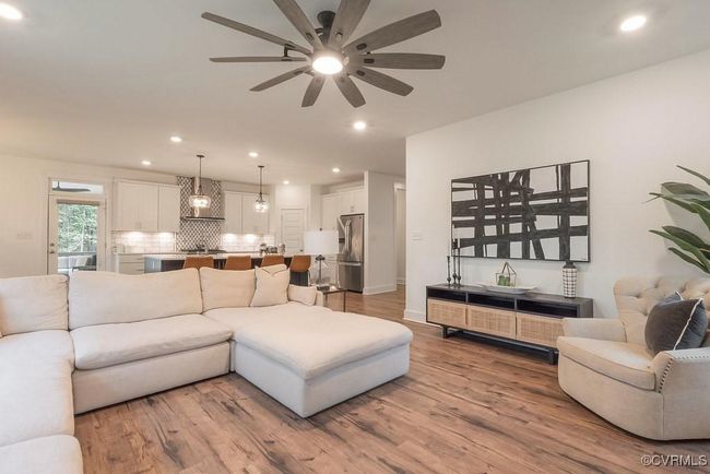Living area featuring wood finished floors, ceiling fan, and recessed lighting | Image 24