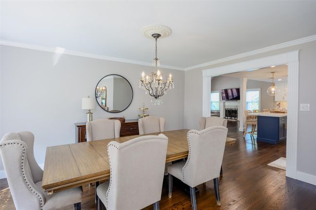 Dining space featuring crown molding, a chandelier, and dark wood finished floors | Image 16