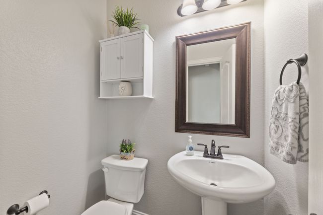 Half bath with upgraded mirror and cabinet. | Image 23