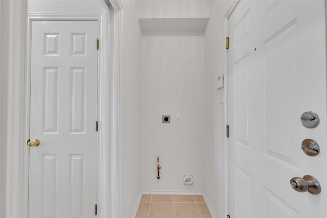 Washroom with electric dryer hookup and light tile patterned flooring | Image 11