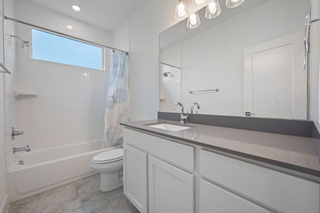 Bathroom featuring shower / bath combo and vanity | Image 17