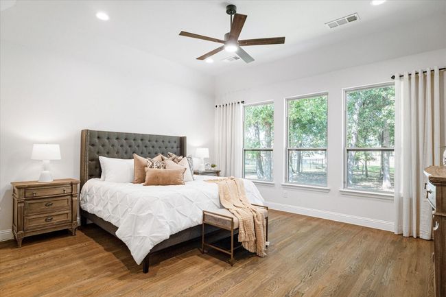 Bedroom featuring multiple windows, wood finished floors, recessed lighting, and ceiling fan | Image 15