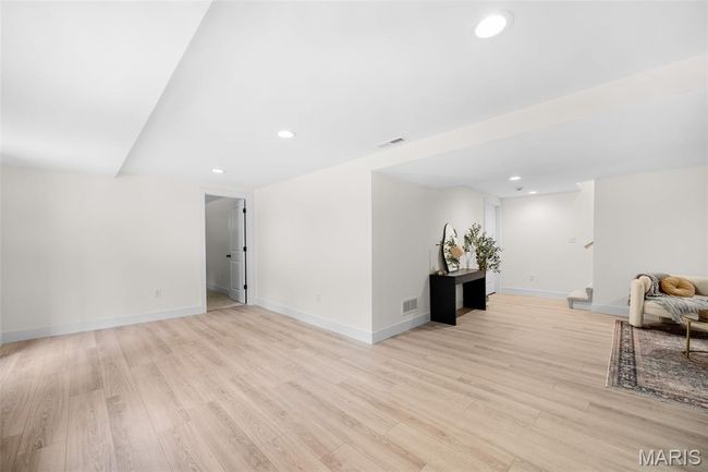 Living room with light wood-style flooring, recessed lighting, and stairs | Image 36