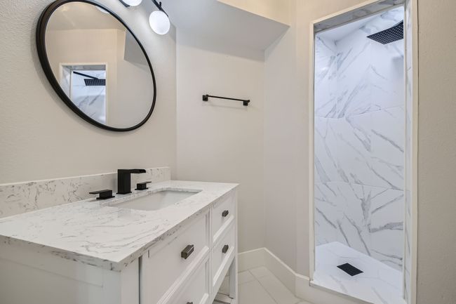Full bath with a marble finish shower and vanity | Image 23