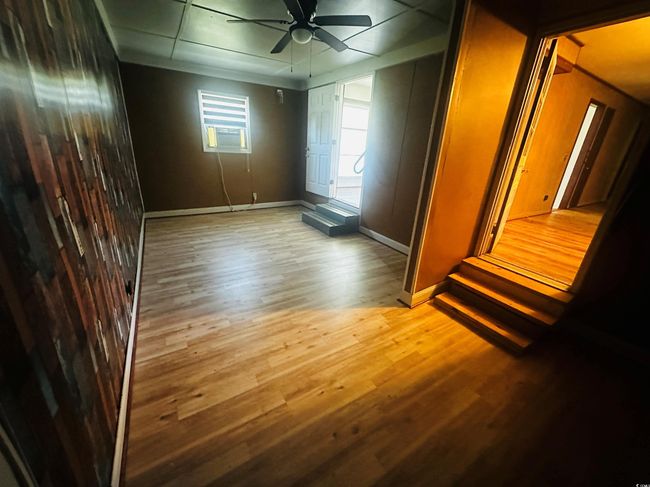 Spare room featuring baseboards, ceiling fan, and wood finished floors | Image 8