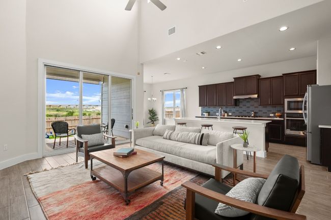Living room featuring light wood finished floors, ceiling fan, recessed lighting, and a towering ceiling | Image 20