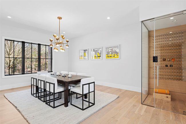 Dining space featuring light wood-type flooring, a chandelier, baseboards, and recessed lighting | Image 35