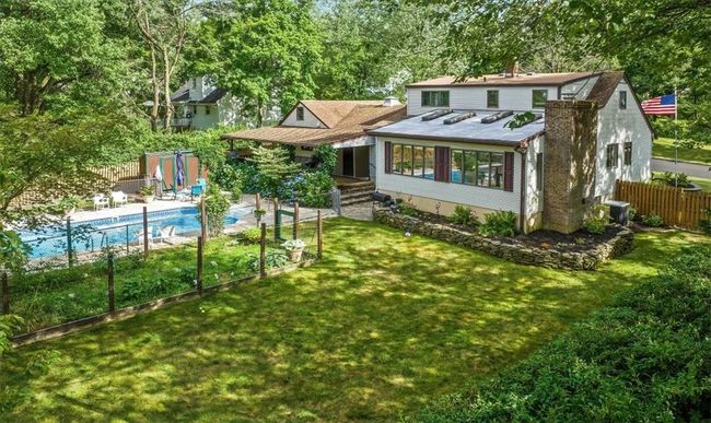 Rear view of property featuring a yard and a fenced in pool | Image 29